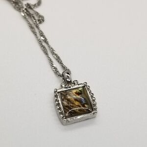 silver tone necklace with abalone-style pendant